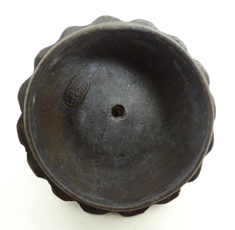 A small dark brown unglazed ceramic teapot featuring a lobed body and a bird-shaped finial on the lid. View VIII