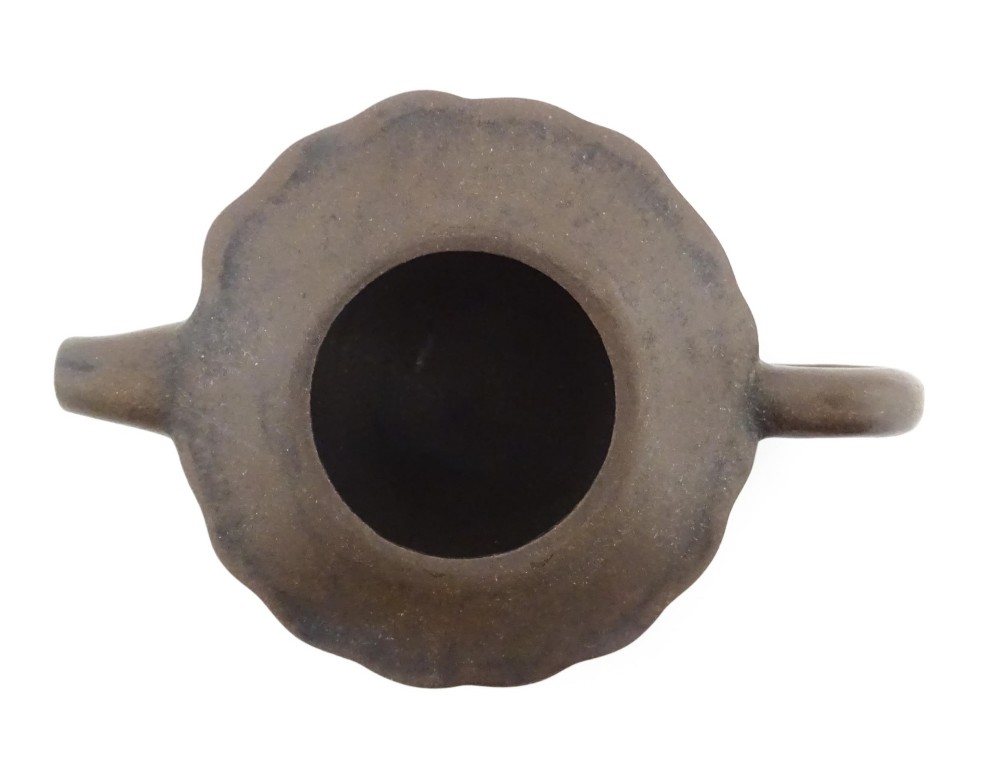 A small dark brown unglazed ceramic teapot featuring a lobed body and a bird-shaped finial on the lid. View XII