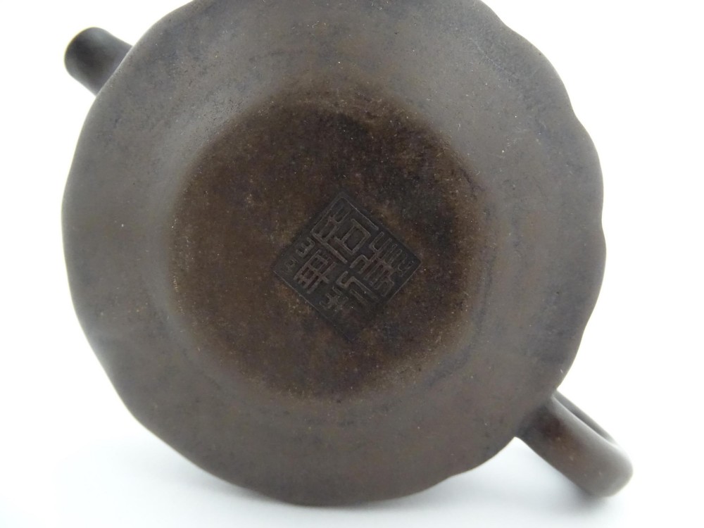 A small dark brown unglazed ceramic teapot featuring a lobed body and a bird-shaped finial on the lid. View XIV