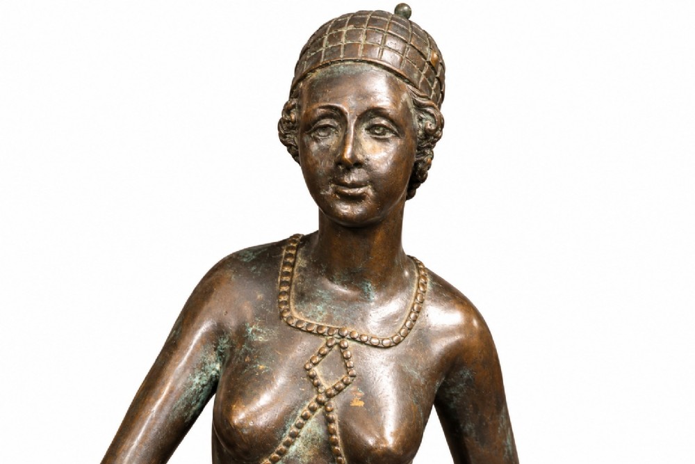 A dark bronze Art Deco sculpture depicting a stylised woman walking two greyhounds on thin chains, set on a dark polished marble base. View IV