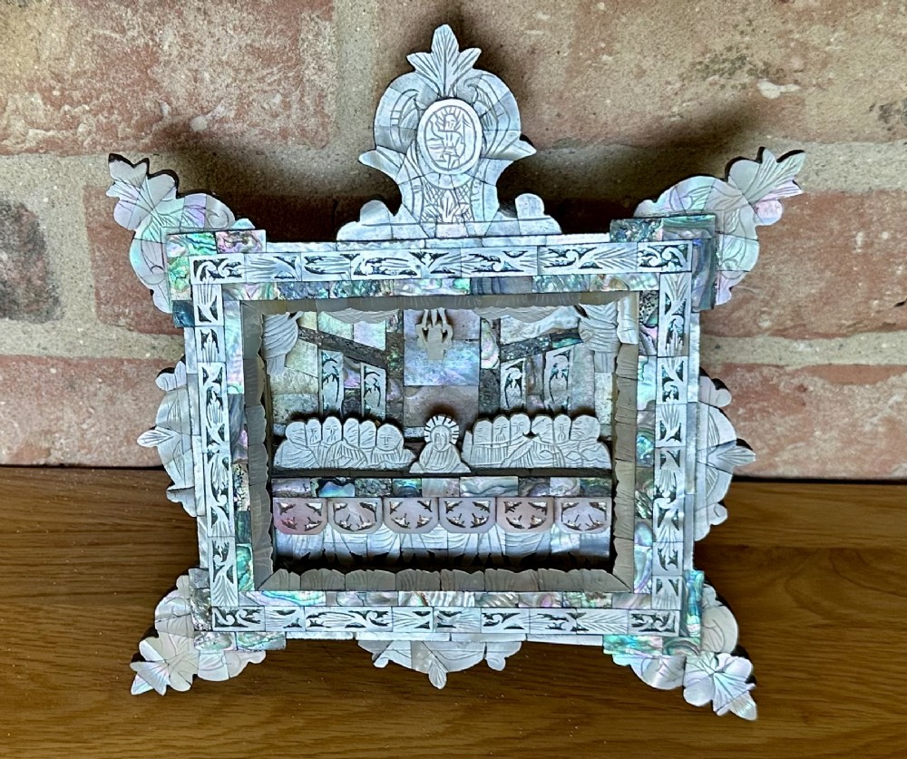 An antique hand-carved mother of pearl and abalone shell diorama frame depicting the Last Supper with elaborate cresting. View II