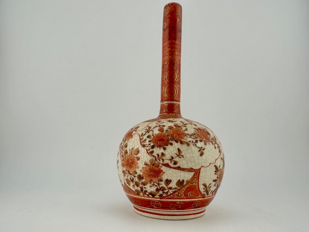 A Japanese Kutani porcelain bottle vase with a tall narrow neck, featuring iron red and gilt floral decoration over a cream crackle glaze body. View III