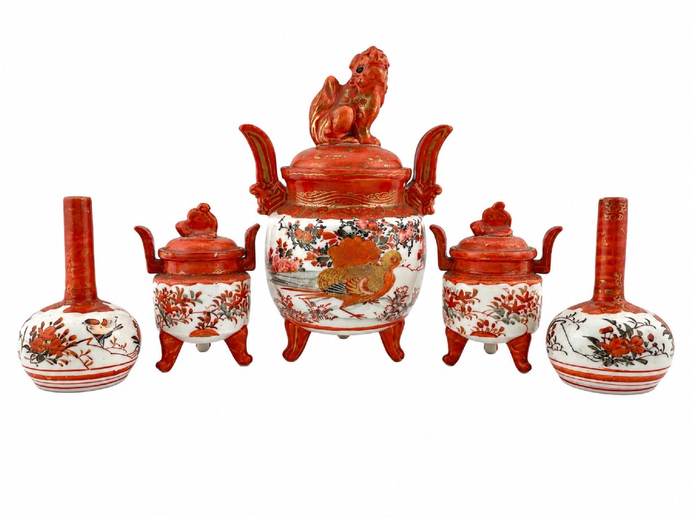 A five-piece Japanese Kutani porcelain garniture set featuring three tripod censers with shishi lion lids and two bottleneck vases in iron-red and polychrome enamel detailing.