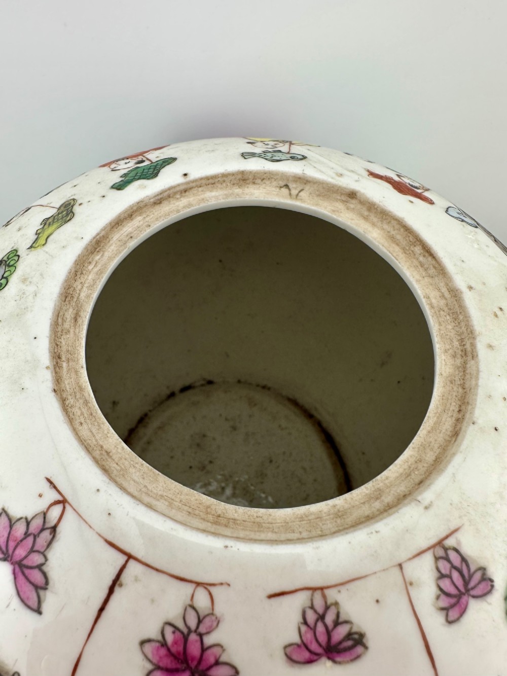 A rounded white porcelain covered jar featuring hand-painted colourful enamels depicting a dragon festival procession with children. View VIII
