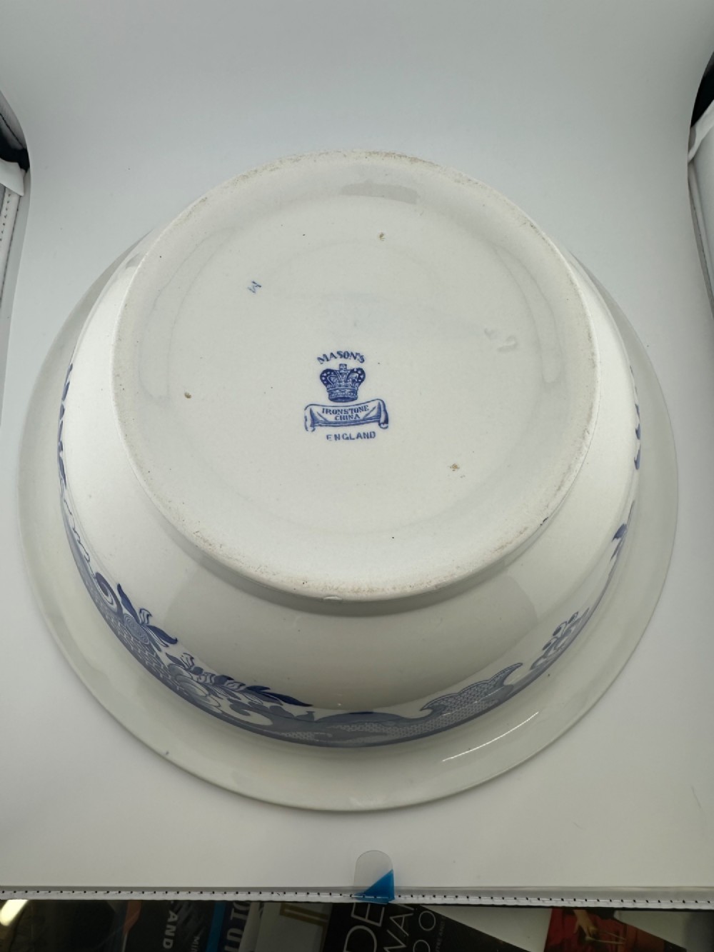 A circular antique blue and white ironstone wash basin bowl featuring a central Chinoiserie landscape scene surrounded by ornate floral and geometric borders. View VII