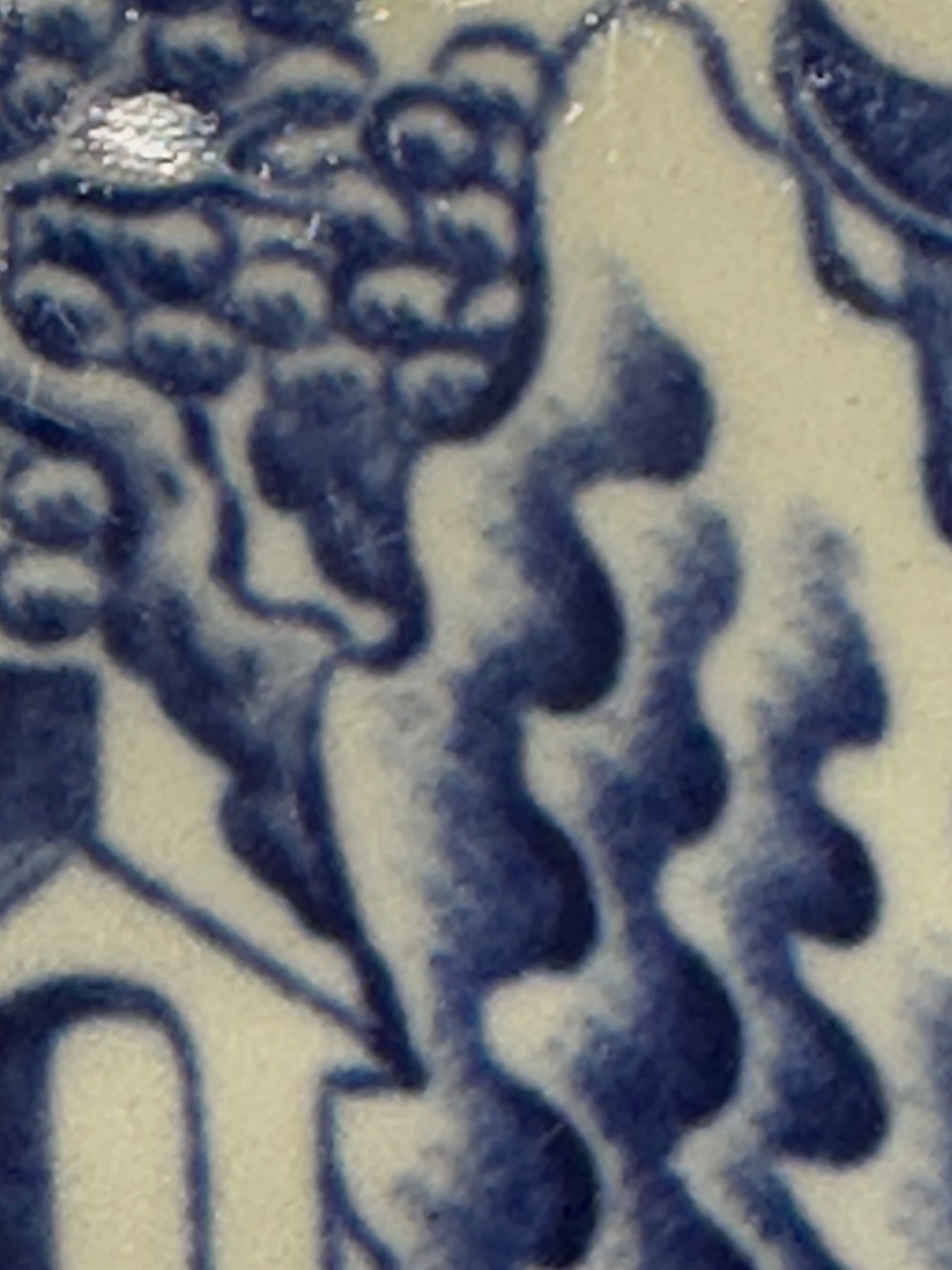 A circular antique blue and white ironstone wash basin bowl featuring a central Chinoiserie landscape scene surrounded by ornate floral and geometric borders. View XV