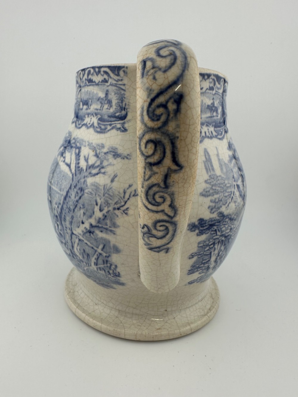An early Victorian blue and white transferware ceramic jug featuring a pastoral cattle scene with fine glaze crazing throughout. View III