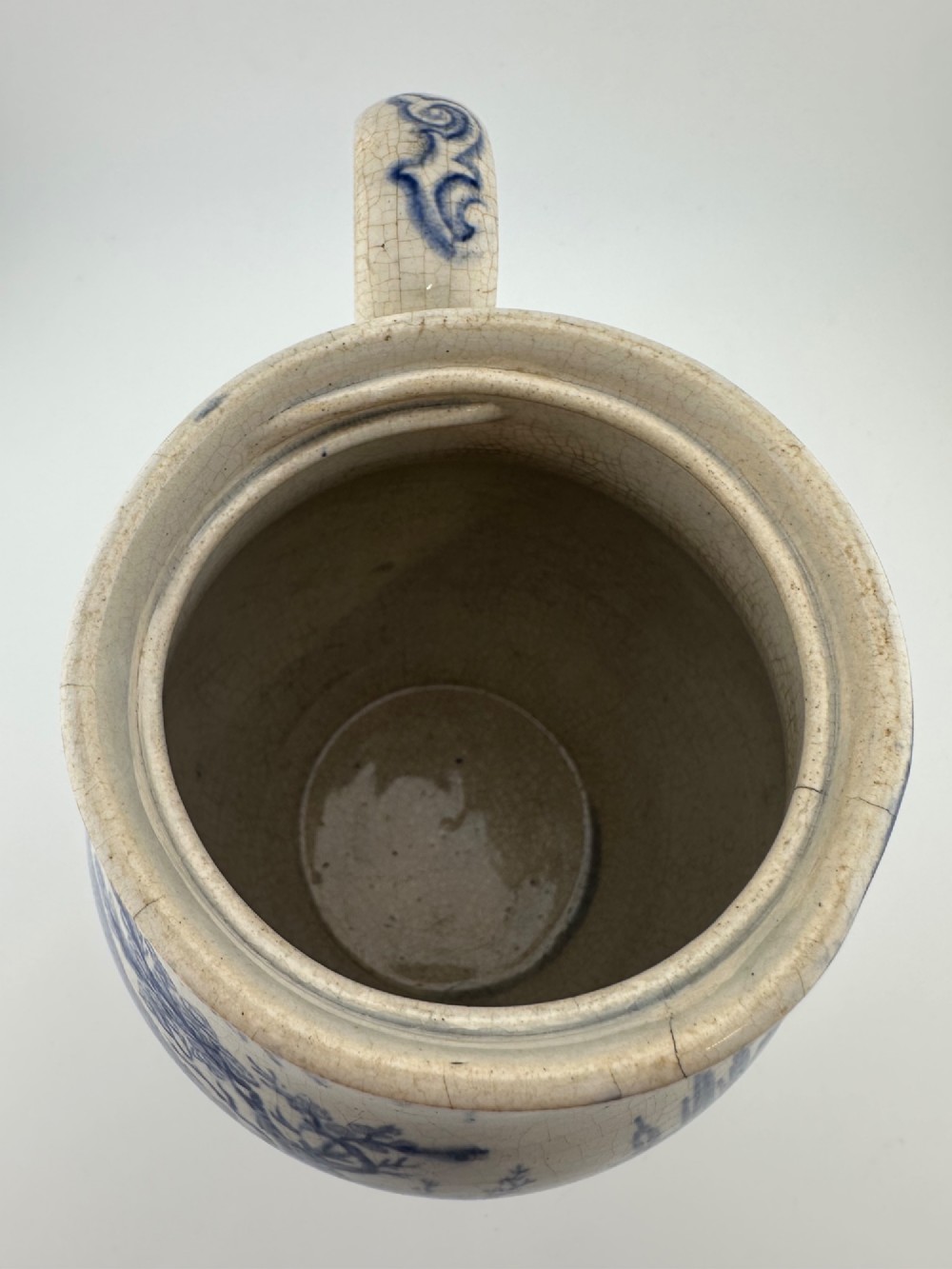 An early Victorian blue and white transferware ceramic jug featuring a pastoral cattle scene with fine glaze crazing throughout. View VII