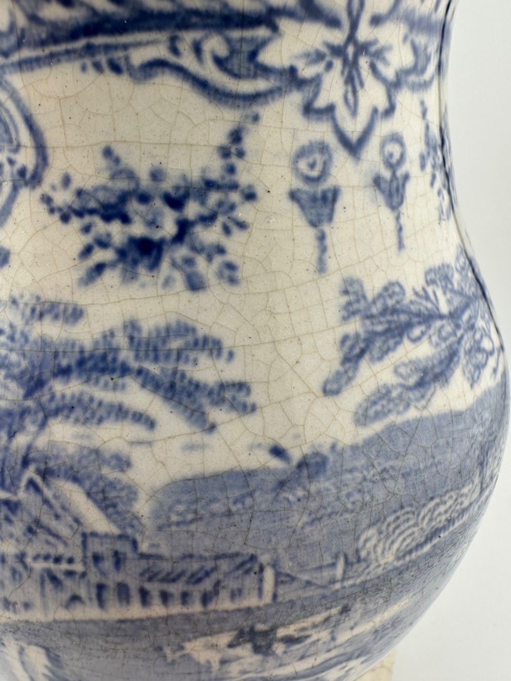 An early Victorian blue and white transferware ceramic jug featuring a pastoral cattle scene with fine glaze crazing throughout. View VIII