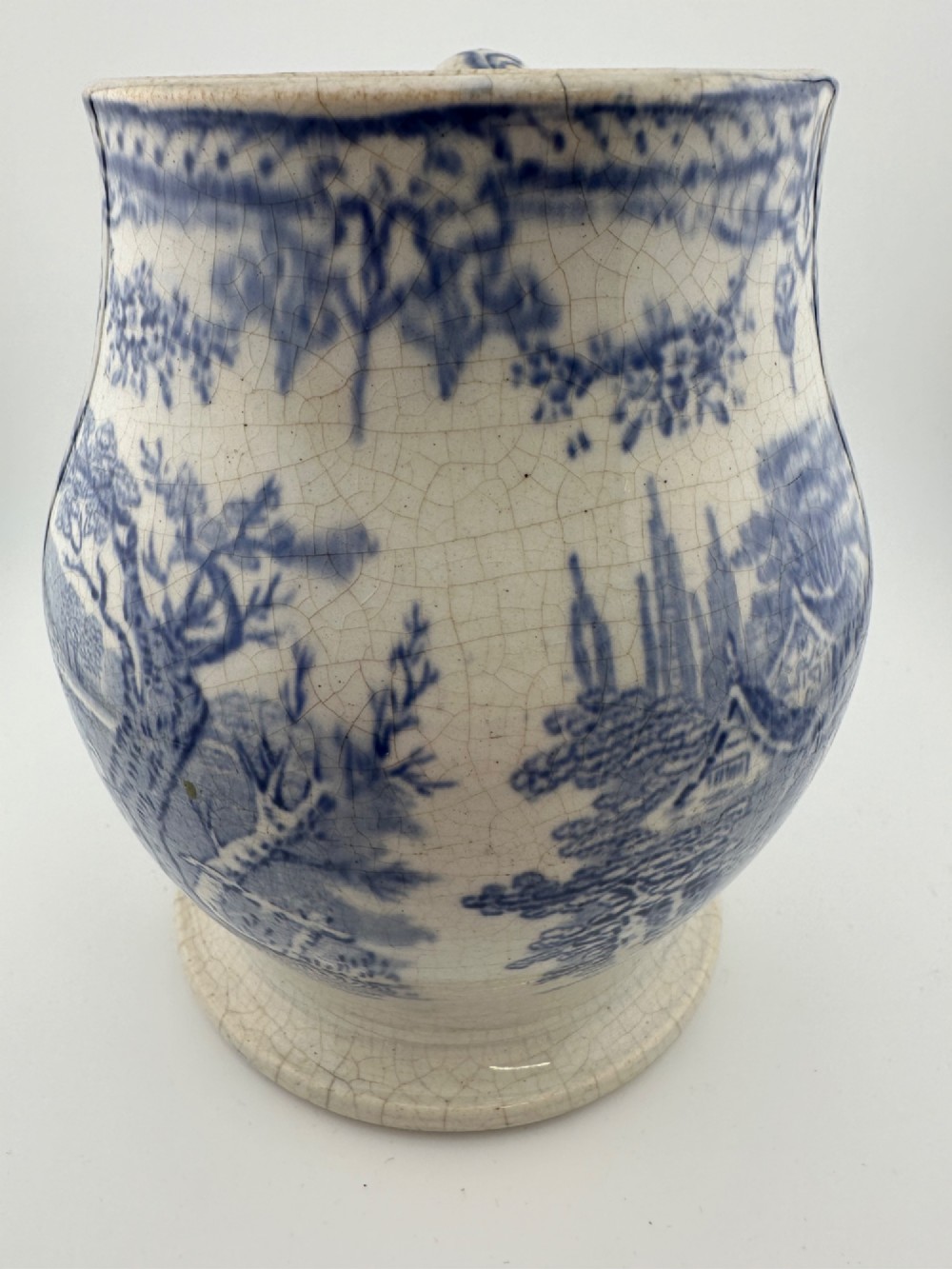An early Victorian blue and white transferware ceramic jug featuring a pastoral cattle scene with fine glaze crazing throughout. View XIII