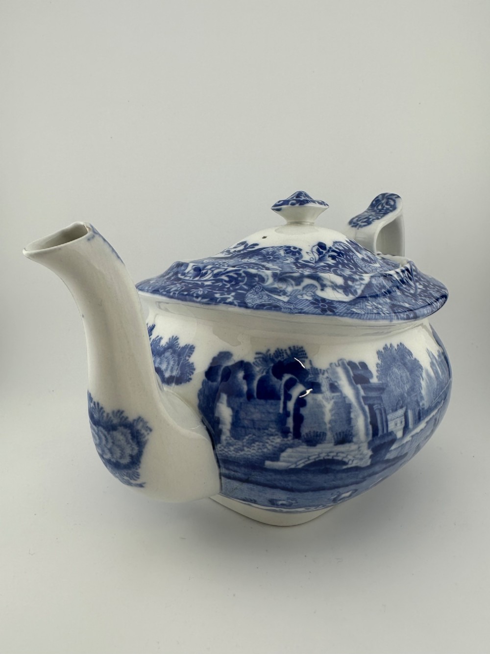 An antique blue and white transferware ceramic teapot in the Copeland Spode Blue Italian pattern featuring an Egyptian shape profile. View II