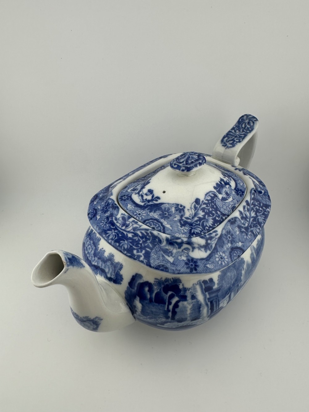 An antique blue and white transferware ceramic teapot in the Copeland Spode Blue Italian pattern featuring an Egyptian shape profile. View V
