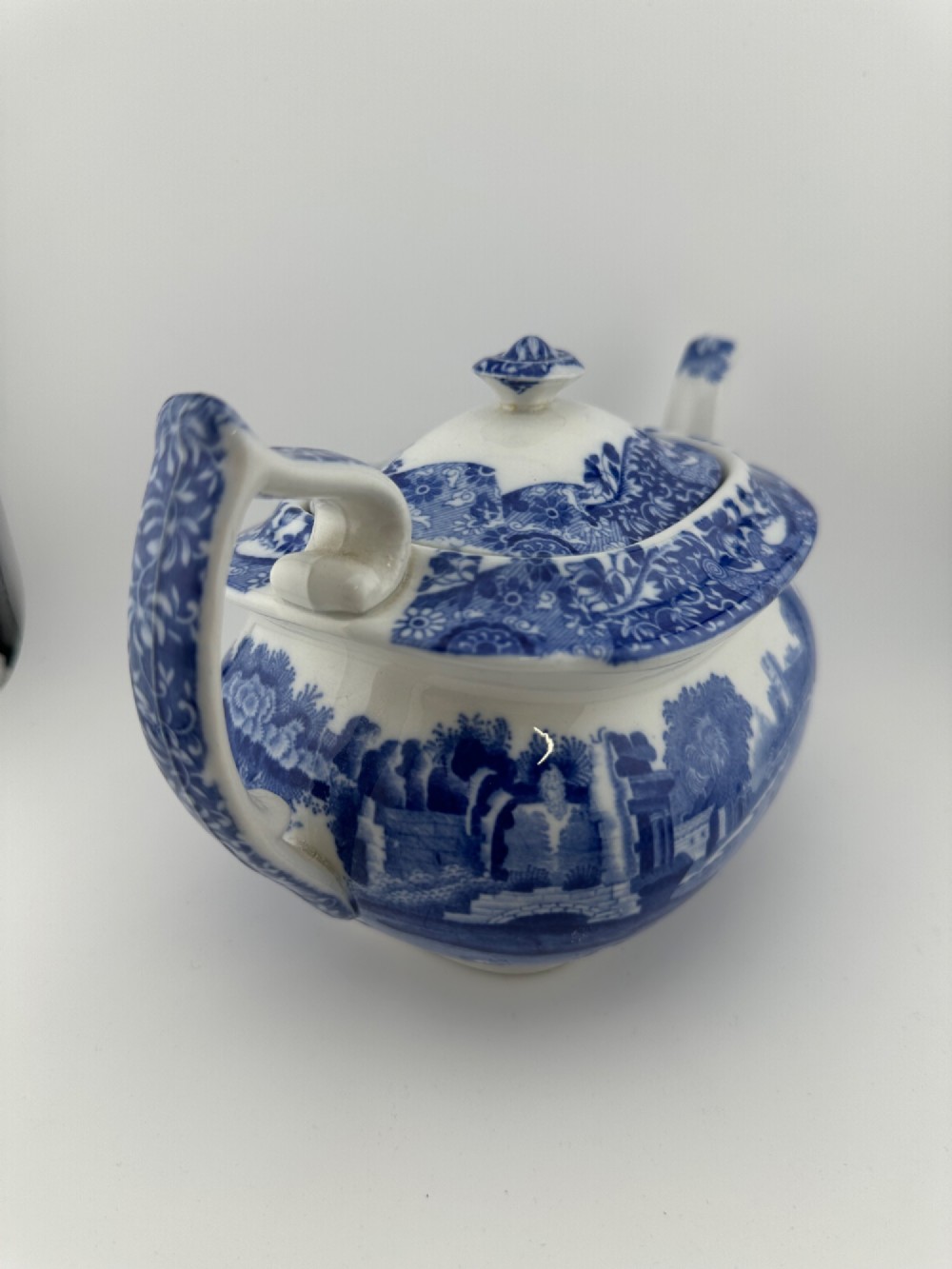 An antique blue and white transferware ceramic teapot in the Copeland Spode Blue Italian pattern featuring an Egyptian shape profile. View VI