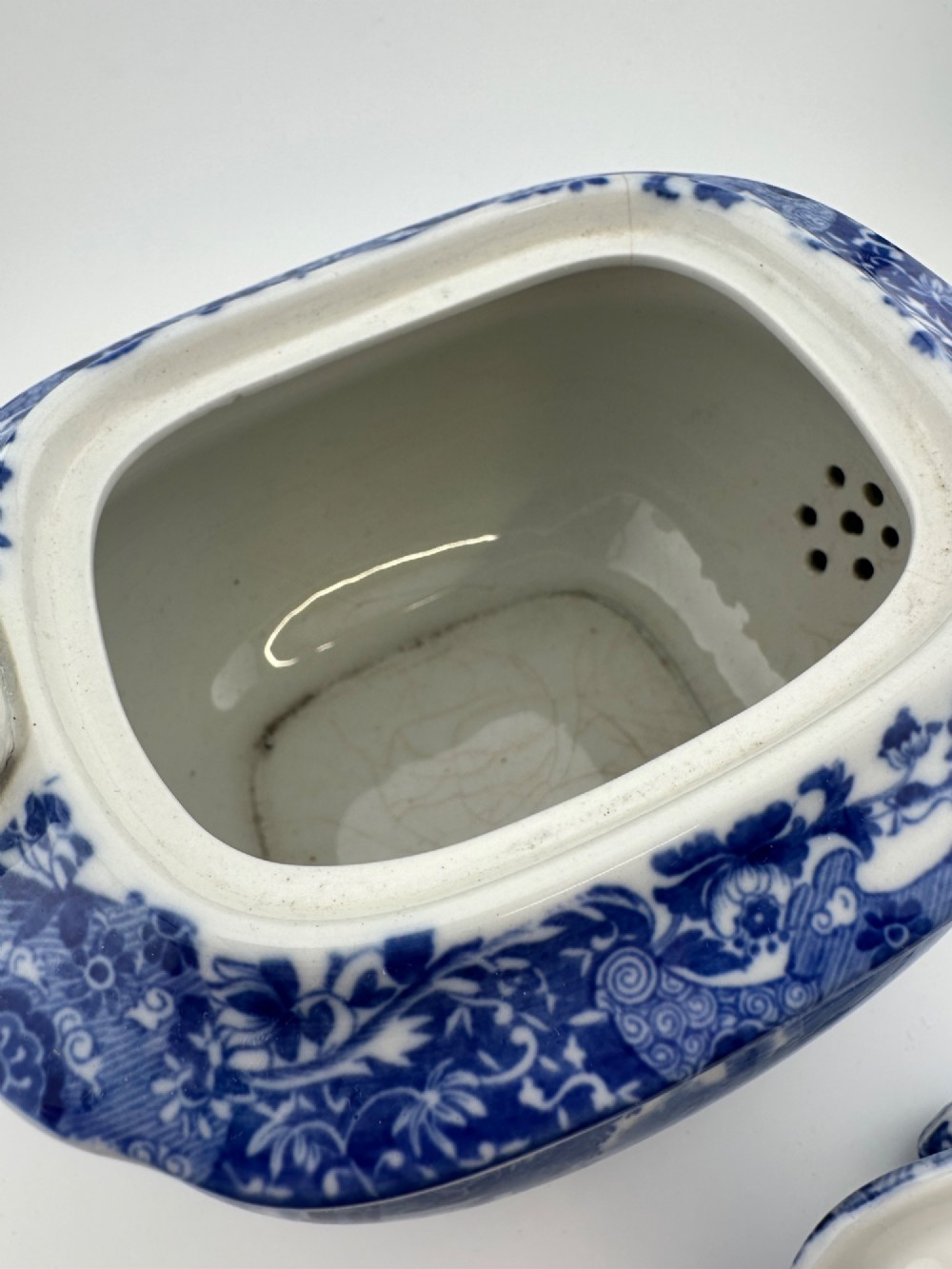 An antique blue and white transferware ceramic teapot in the Copeland Spode Blue Italian pattern featuring an Egyptian shape profile. View X