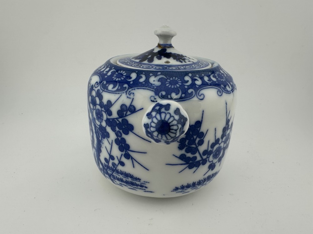 A Japanese Meiji period blue and white porcelain incense burner decorated with hand-painted prunus branches, featuring a fitted lid and side lugs. View IV