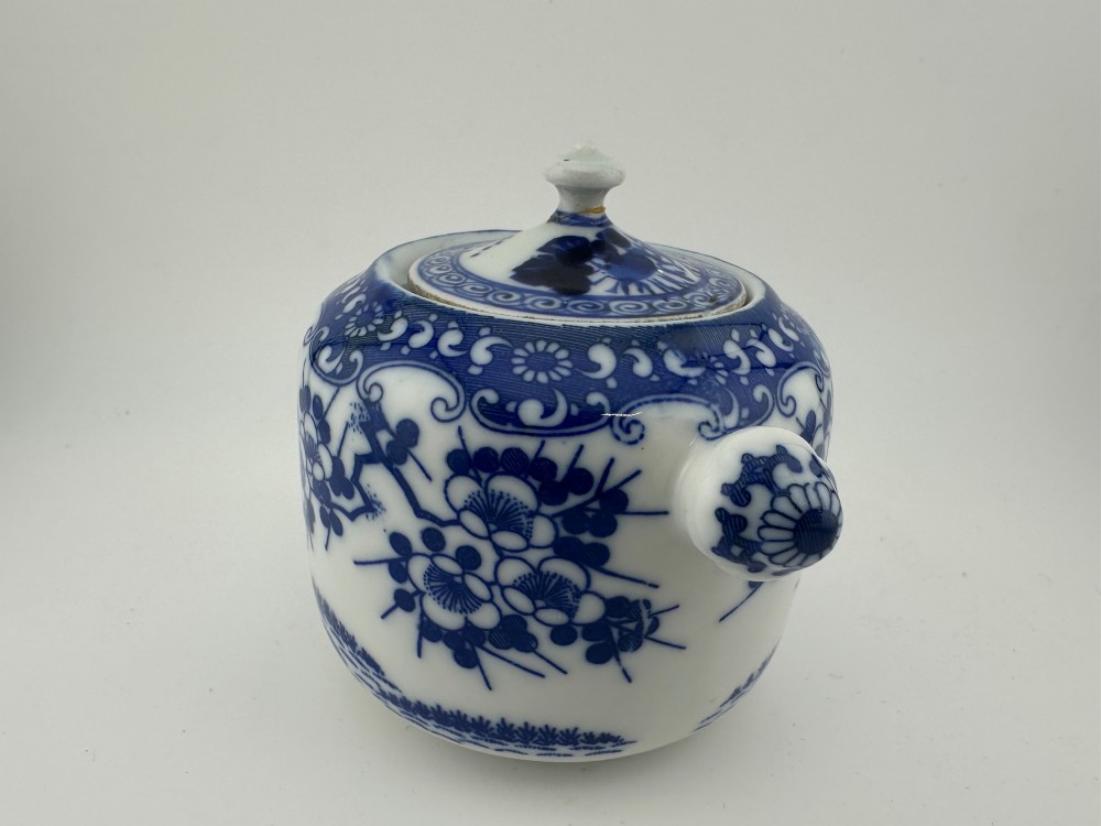 A Japanese Meiji period blue and white porcelain incense burner decorated with hand-painted prunus branches, featuring a fitted lid and side lugs. View VI