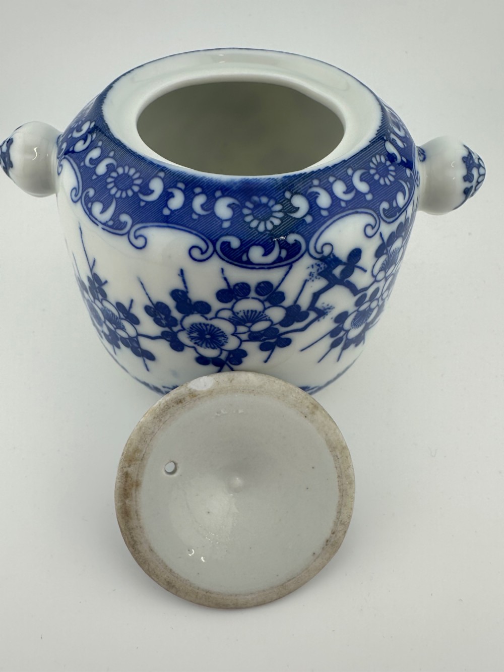 A Japanese Meiji period blue and white porcelain incense burner decorated with hand-painted prunus branches, featuring a fitted lid and side lugs. View VII
