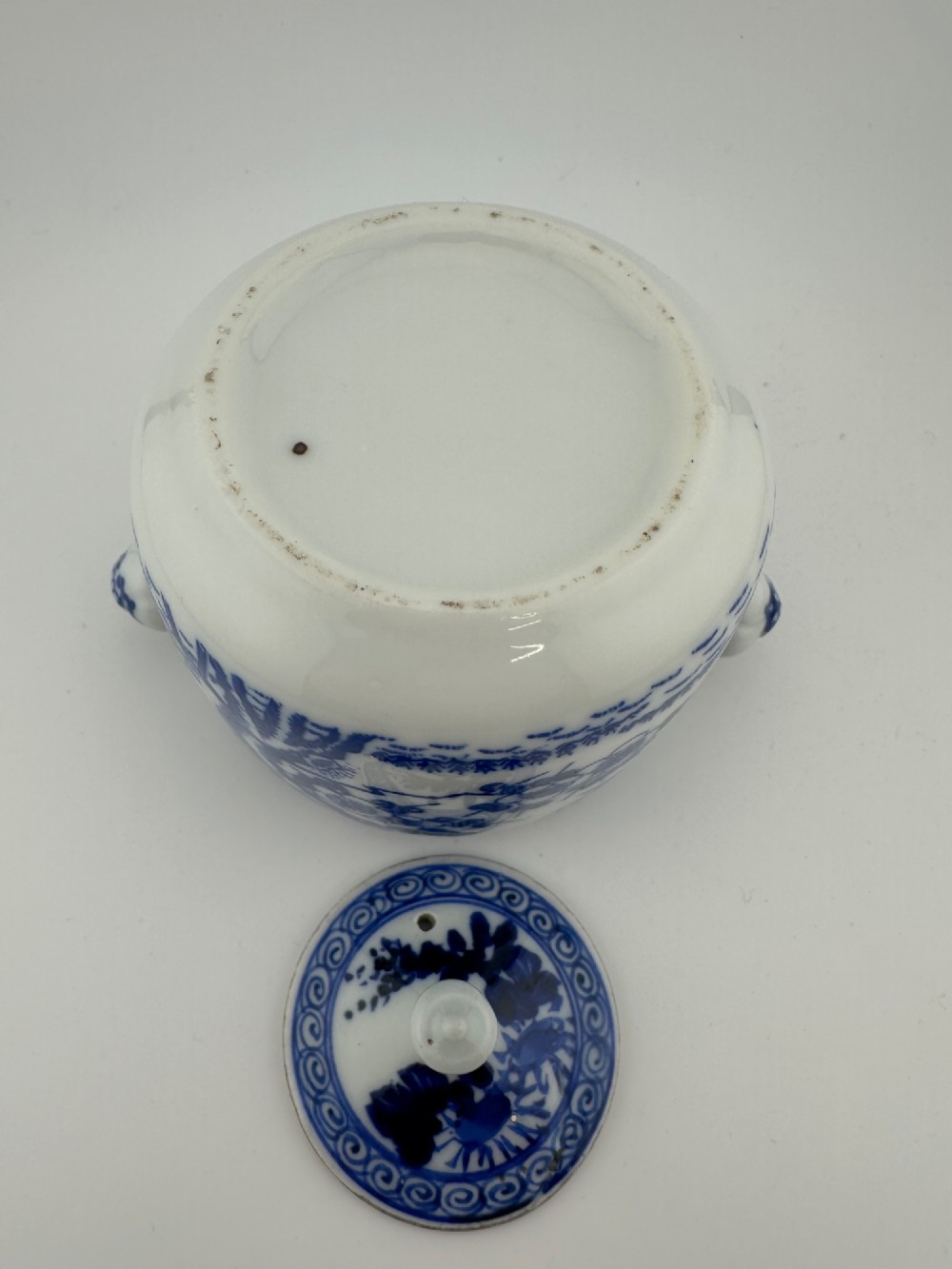 A Japanese Meiji period blue and white porcelain incense burner decorated with hand-painted prunus branches, featuring a fitted lid and side lugs. View IX