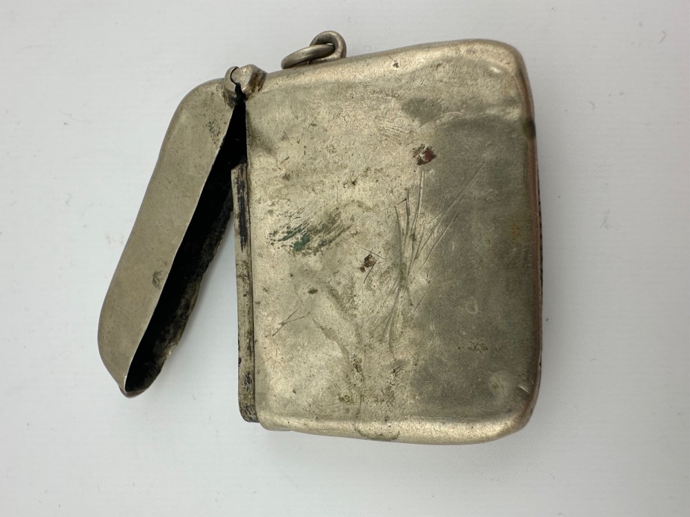 An antique rectangular silver-plated vesta case featuring hand-engraved scrollwork, an open hinged lid, and a side suspension ring. View IV