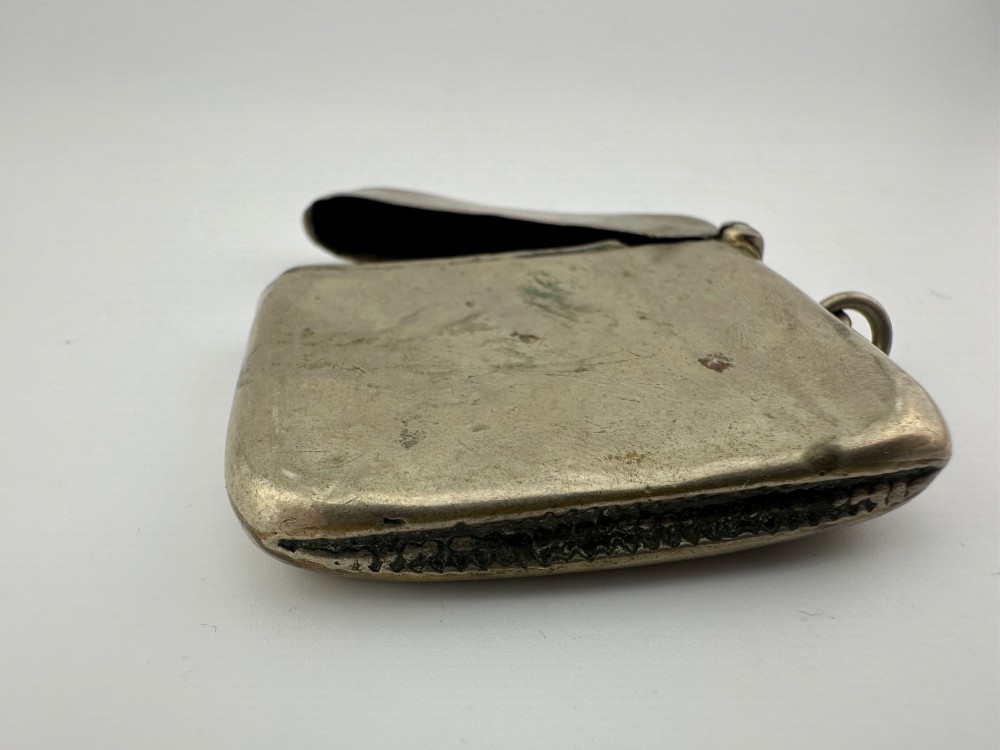 An antique rectangular silver-plated vesta case featuring hand-engraved scrollwork, an open hinged lid, and a side suspension ring. View V