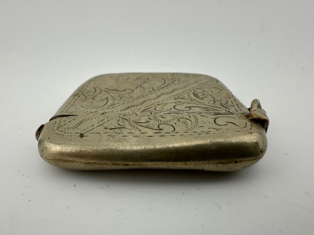 An antique rectangular silver-plated vesta case featuring hand-engraved scrollwork, an open hinged lid, and a side suspension ring. View VII
