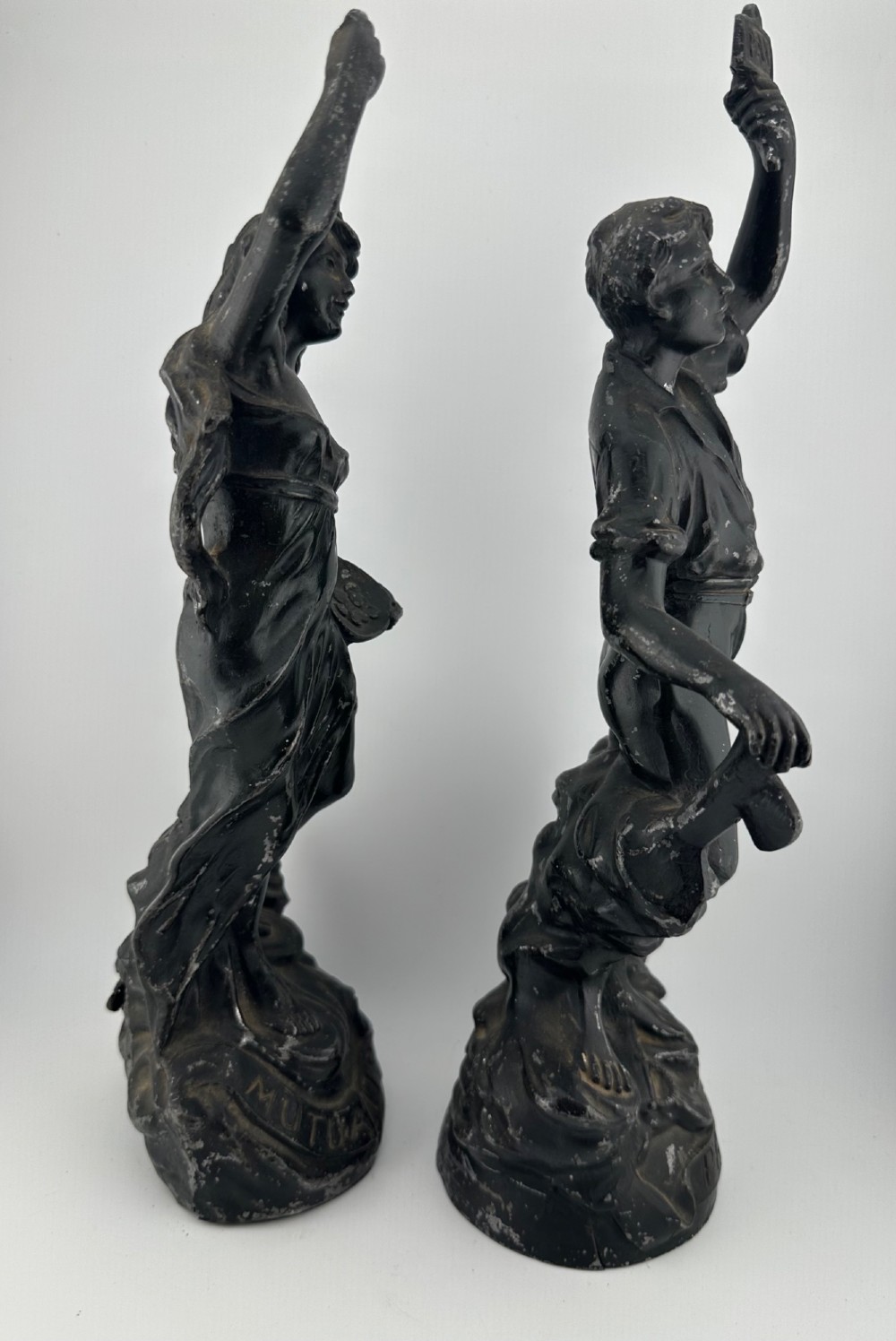 A pair of dark bronze-finished French spelter allegorical figures raised on moulded circular bases representing Mutualite and Paix. View VII
