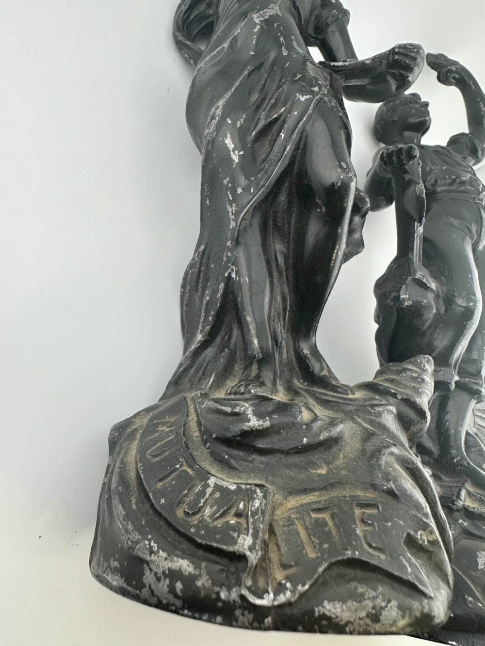 A pair of dark bronze-finished French spelter allegorical figures raised on moulded circular bases representing Mutualite and Paix. View XIII