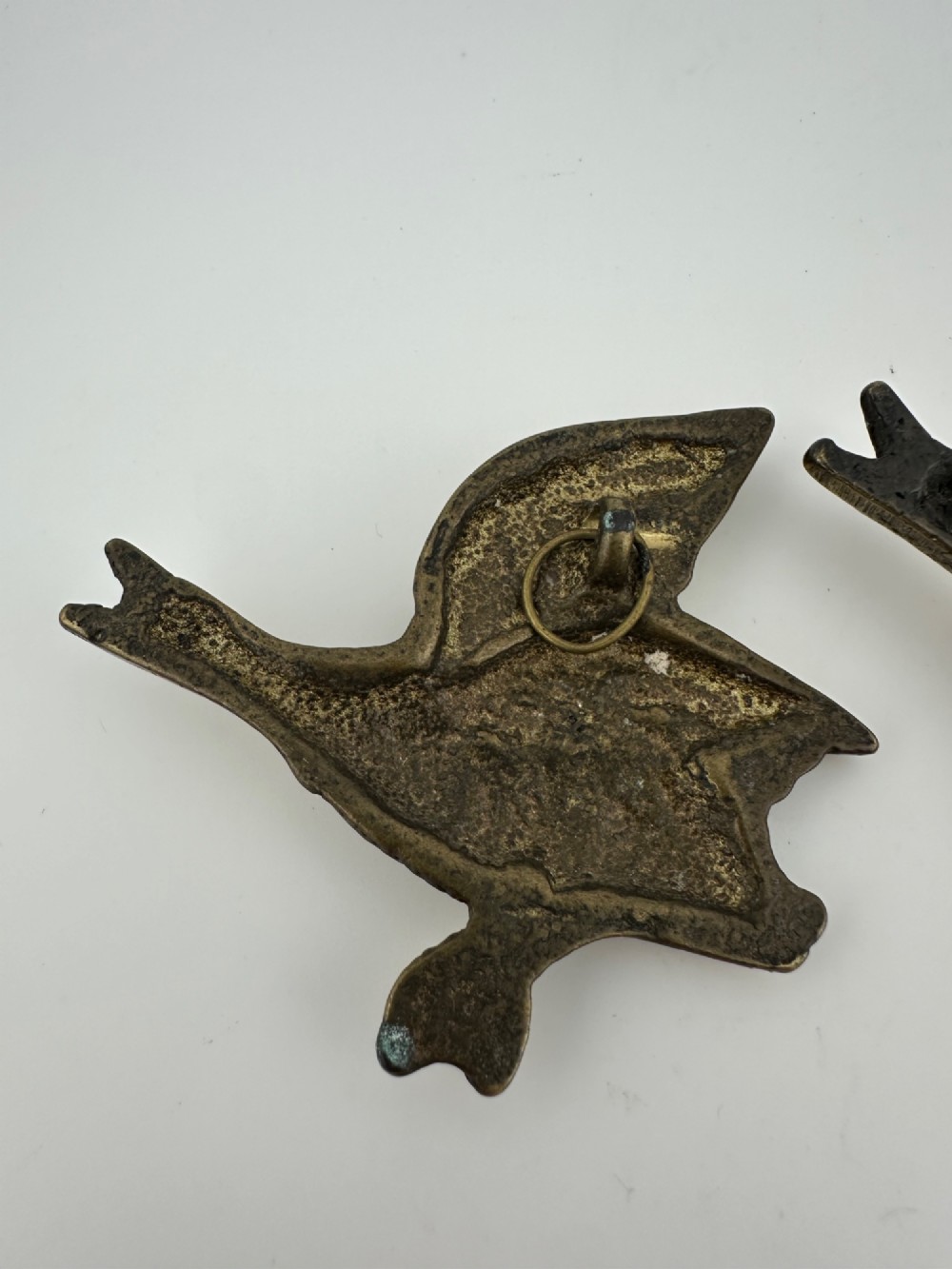 A set of three graduated cast brass flying geese wall plaques arranged by size with textured feather detailing. View IX