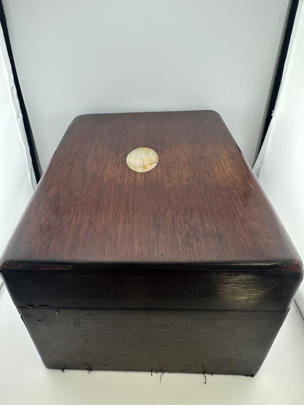 An open Victorian rosewood vanity box featuring a ruched green velvet lid lining, fitted interior compartments with silver-capped glass bottles, and a mother-of-pearl escutcheon. View VII