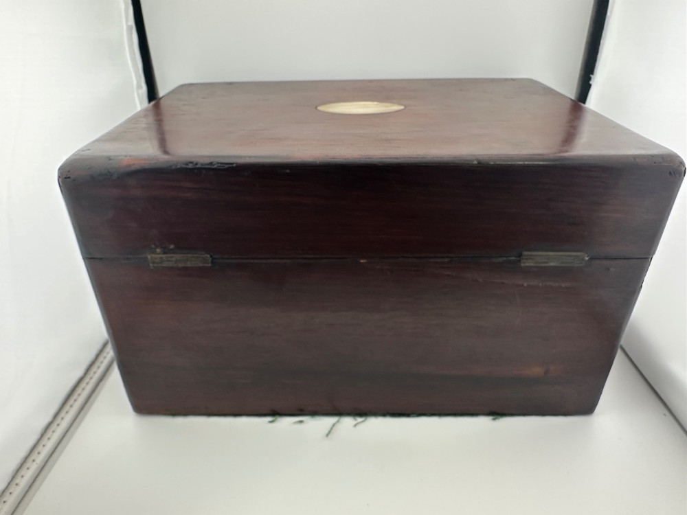An open Victorian rosewood vanity box featuring a ruched green velvet lid lining, fitted interior compartments with silver-capped glass bottles, and a mother-of-pearl escutcheon. View IX