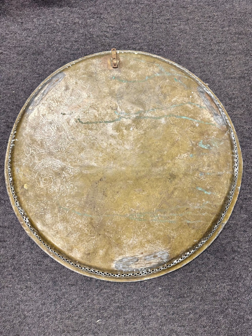 A circular antique brass tray featuring an intricately engraved swirling floral pattern and a pierced gallery rim. View IV
