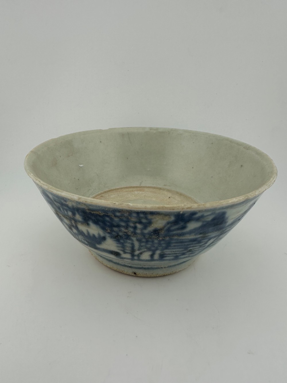 A nineteenth century Chinese Qing Dynasty shipwreck porcelain bowl decorated with cobalt blue underglaze landscape imagery. View II
