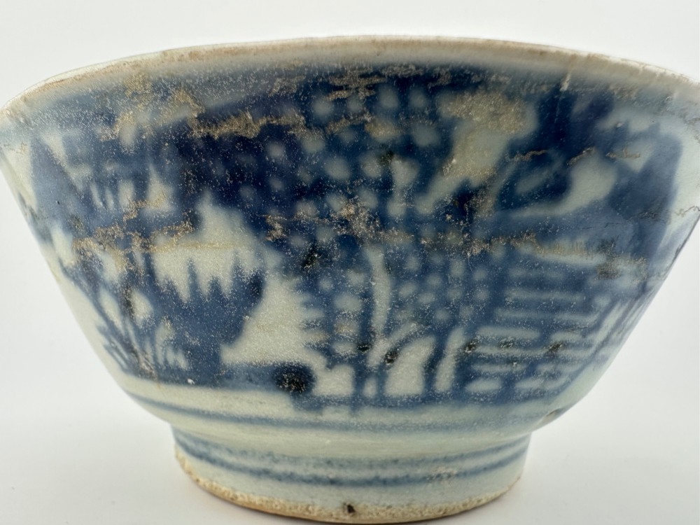 A nineteenth century Chinese Qing Dynasty shipwreck porcelain bowl decorated with cobalt blue underglaze landscape imagery. View V