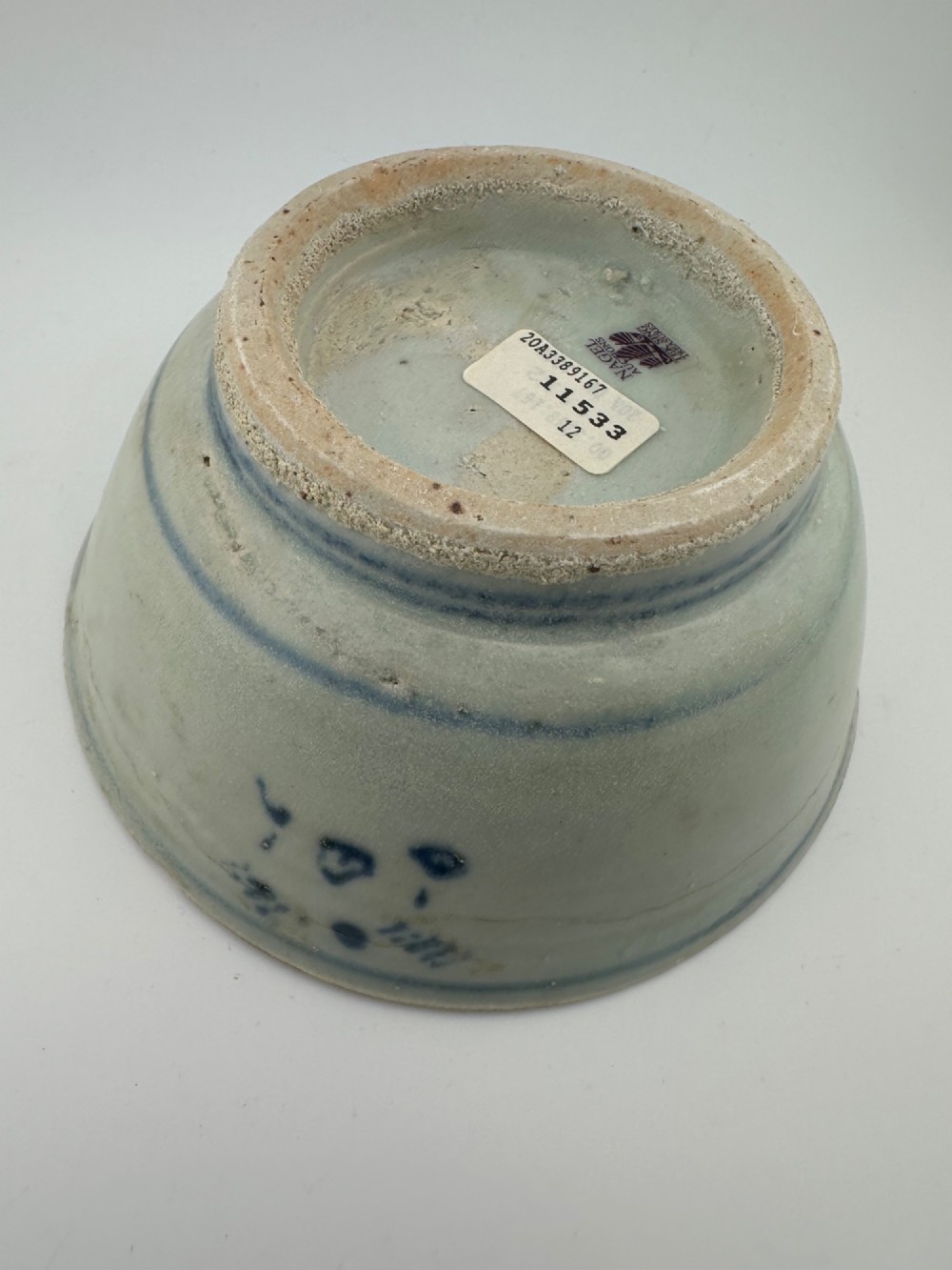 A nineteenth century Chinese Qing Dynasty shipwreck porcelain bowl decorated with cobalt blue underglaze landscape imagery. View X
