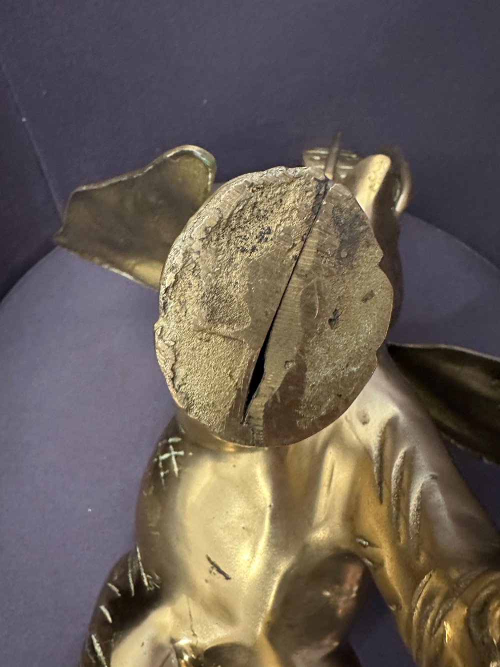 A solid brass sculpture of an elephant standing with its trunk raised up. View XII