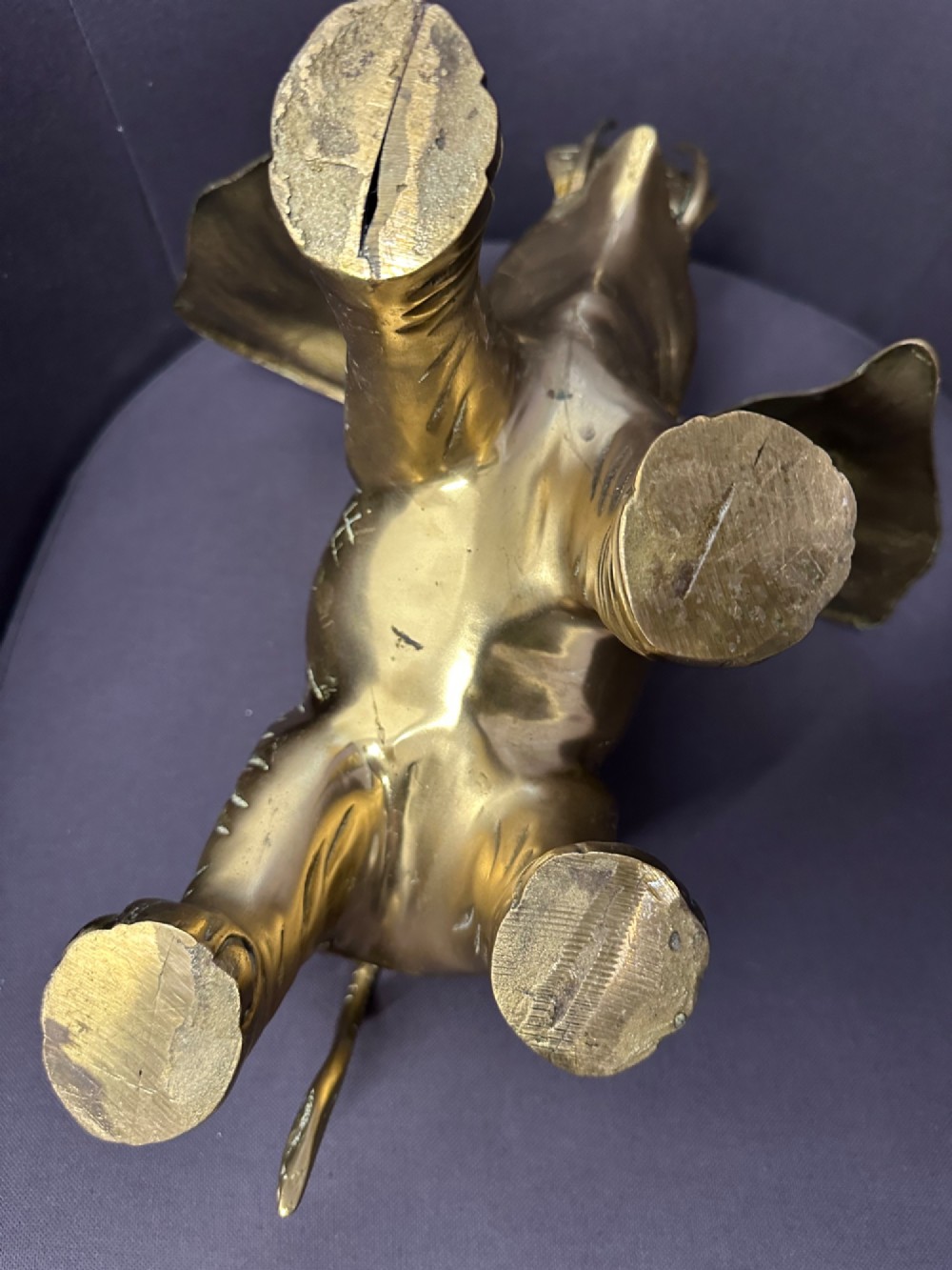 A solid brass sculpture of an elephant standing with its trunk raised up. View XIII