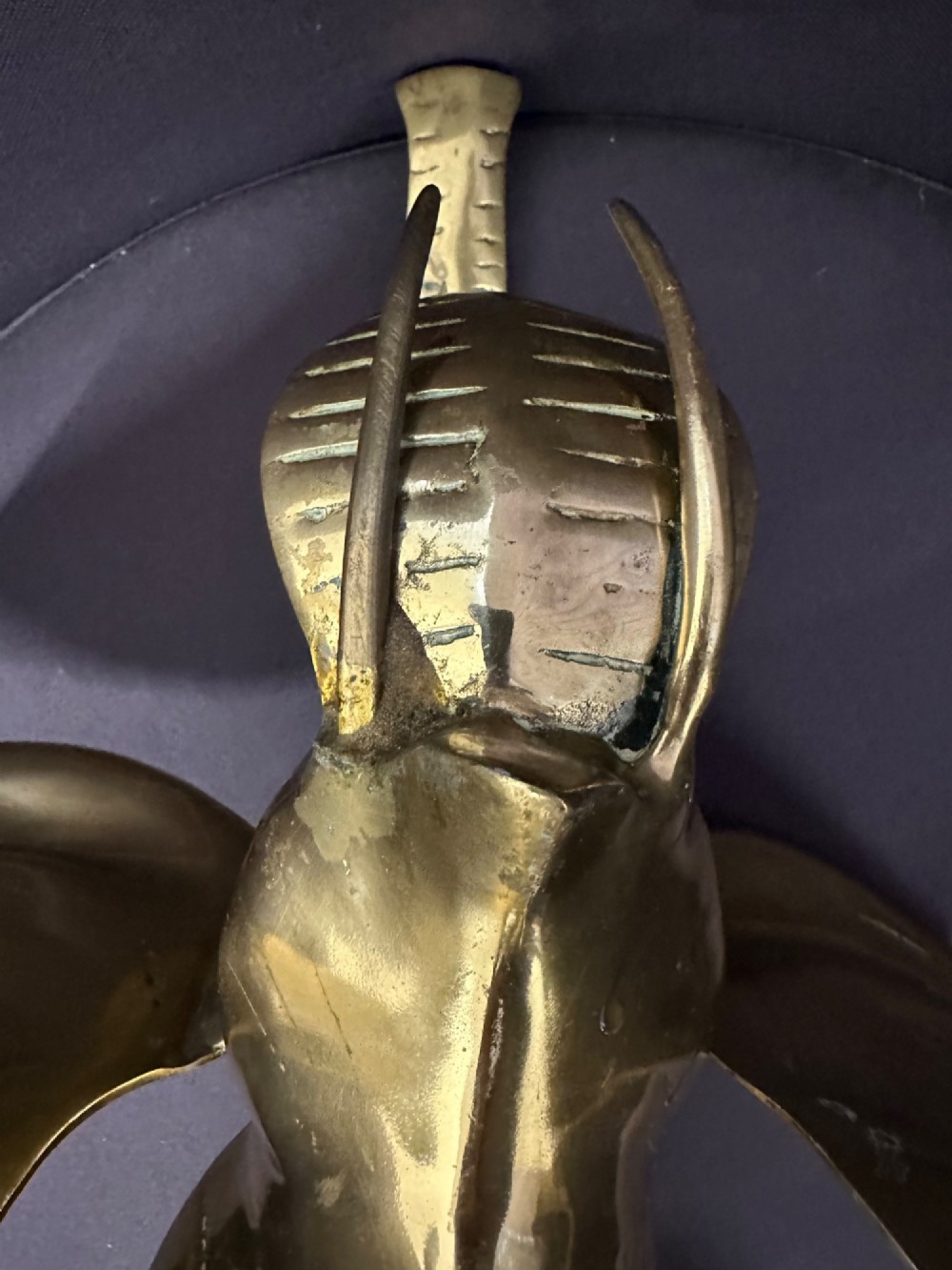 A solid brass sculpture of an elephant standing with its trunk raised up. View XIV