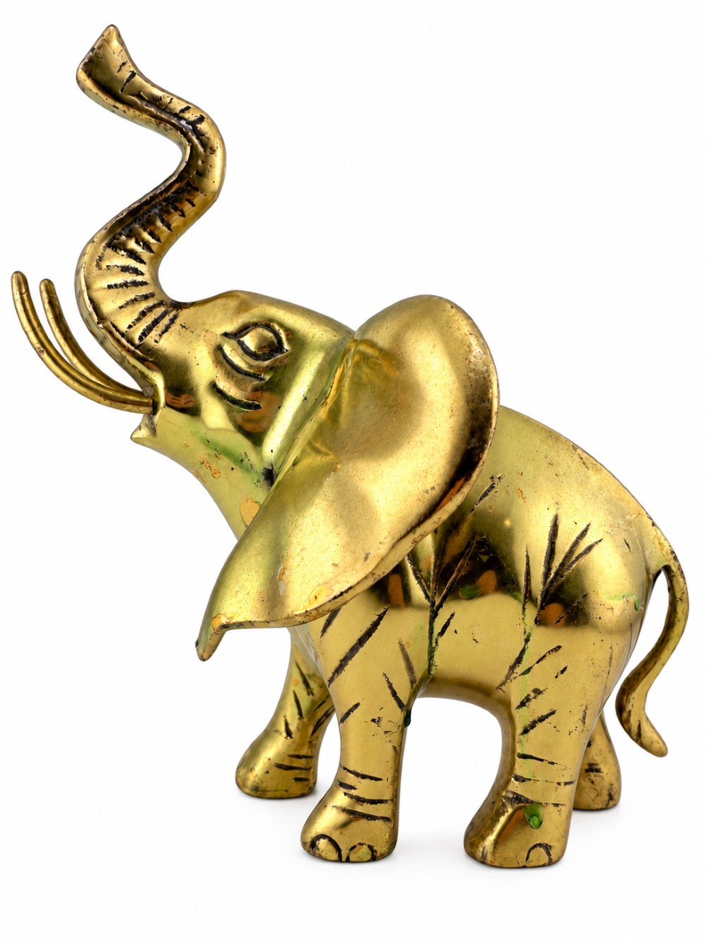 A solid cast brass elephant sculpture with an elevated raised trunk, detailed engraving along the body, and a polished gold finish.