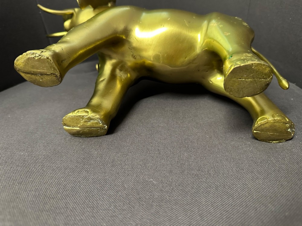 A vintage cast brass elephant sculpture standing with its trunk raised high. View VI