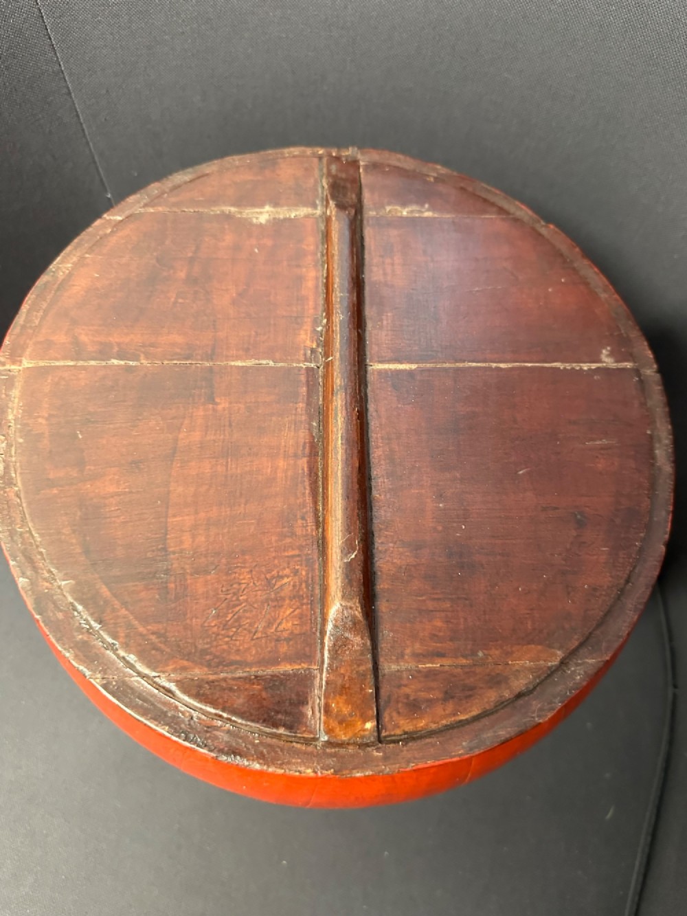 A traditional Chinese red and black lacquered rice basket featuring a high arched handle and painted decorative motifs on the lid. View XIV