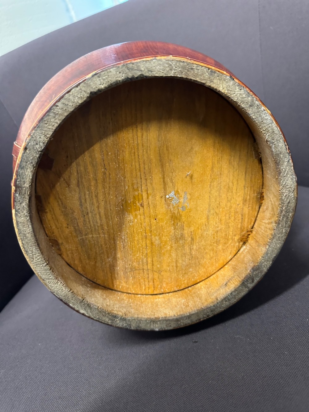 A late Qing Dynasty tiered Chinese food basket crafted from warm amber bamboo and wood, hand-painted with black line illustrations of a child on the lid and floral motifs around the body. View VII