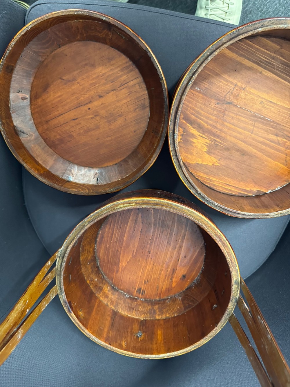 A late Qing Dynasty tiered Chinese food basket crafted from warm amber bamboo and wood, hand-painted with black line illustrations of a child on the lid and floral motifs around the body. View IX