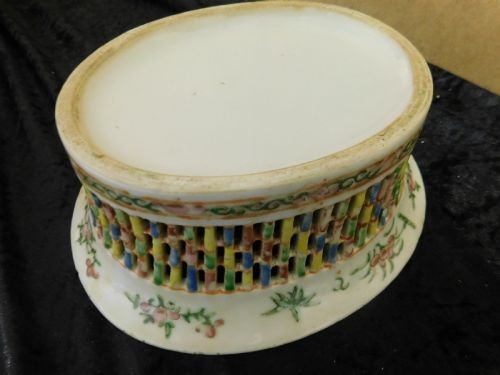 A 19th-century Chinese Famille Rose reticulated porcelain chestnut basket with pierced lattice sides resting near a matching circular undertray. View V