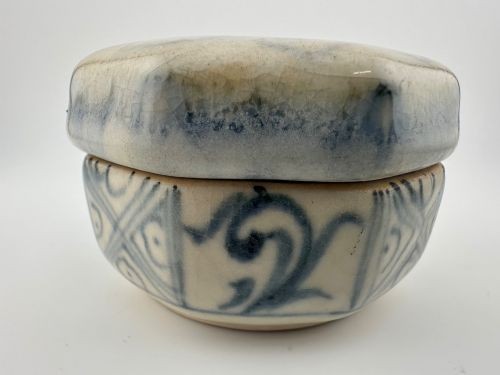 An antique octagonal ceramic lidded box featuring cobalt blue hand-painted scrolling motifs against an off-white glaze. View VII