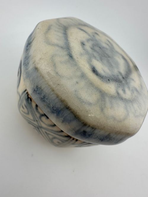 An antique octagonal ceramic lidded box featuring cobalt blue hand-painted scrolling motifs against an off-white glaze. View VIII