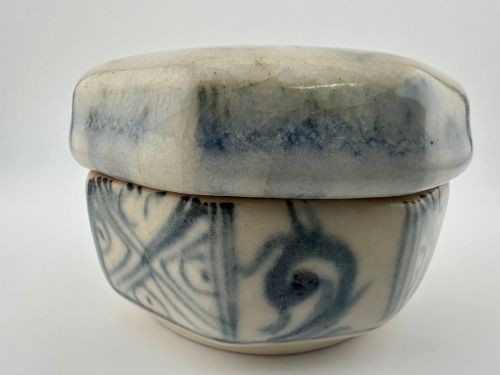 An antique octagonal ceramic lidded box featuring cobalt blue hand-painted scrolling motifs against an off-white glaze. View IX