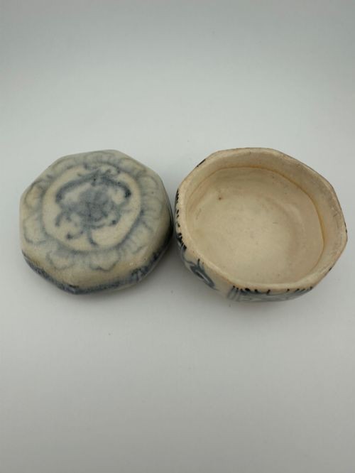 An antique octagonal ceramic lidded box featuring cobalt blue hand-painted scrolling motifs against an off-white glaze. View XIII