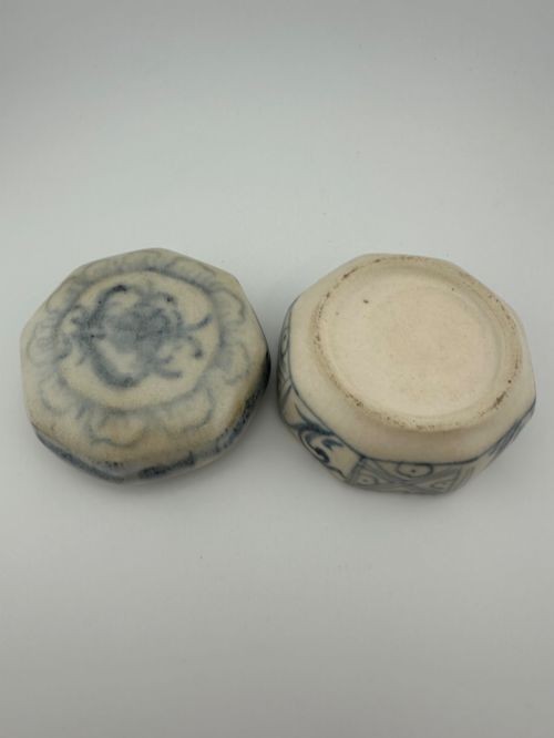 An antique octagonal ceramic lidded box featuring cobalt blue hand-painted scrolling motifs against an off-white glaze. View XIV
