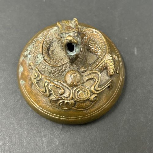 A matching pair of rounded bronze censers featuring relief dragon heads around the body, twin side handles, and sculpted dragon lid finials. View IV