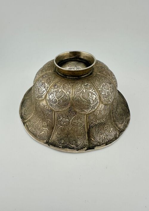 An antique Chinese export white metal footed bowl featuring chased floral patterns and bird motifs within lobed panels. View III